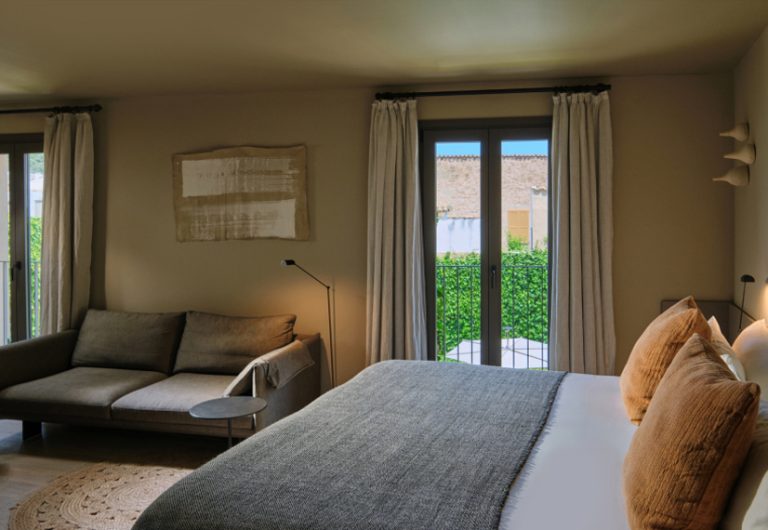 Large neutral room with sofa and balcony garden wall, the Atelier suite at Can Aulí