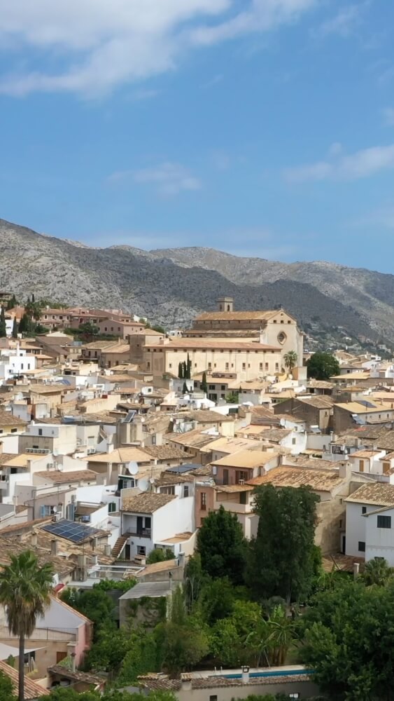 Pollença panorama: the white town, the church, and the Tramuntana mountains rising behind